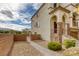 Exterior view of the home showcasing stone accents, a brick-paved walkway, and lush landscaping at 7579 Harwich Bay Ave, Las Vegas, NV 89179