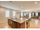 Open concept kitchen with large island, seating, modern appliances, and seamless transition to the dining and living areas at 7579 Harwich Bay Ave, Las Vegas, NV 89179