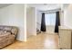 Open living space featuring tiled floors, a staircase, and a comfortable seating area by the window at 7579 Harwich Bay Ave, Las Vegas, NV 89179
