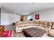 Cozy living room featuring a large sectional sofa and wood-look flooring at 7579 Harwich Bay Ave, Las Vegas, NV 89179