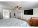 Comfortable main bedroom with ceiling fan, TV, walk-in closet, and adjoining bathroom at 7579 Harwich Bay Ave, Las Vegas, NV 89179
