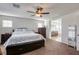 Spacious main bedroom featuring a ceiling fan and ensuite bathroom access at 7579 Harwich Bay Ave, Las Vegas, NV 89179