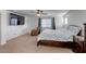 Bright main bedroom featuring a ceiling fan, TV, and a cozy chair at 7579 Harwich Bay Ave, Las Vegas, NV 89179