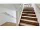 Carpeted staircase with white railing leads to the next level at 7579 Harwich Bay Ave, Las Vegas, NV 89179