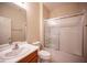 Bathroom featuring a double sink vanity, a toilet and a glass door shower-tub combination at 7726 Coast Jay St, North Las Vegas, NV 89084