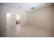 Spacious bedroom featuring neutral paint, tile flooring and an adjacent bathroom at 7726 Coast Jay St, North Las Vegas, NV 89084