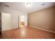 Neutral bedroom featuring wood flooring with an open door to bathroom at 7726 Coast Jay St, North Las Vegas, NV 89084