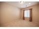 This bedroom features tan walls, tan flooring and curtains at 7726 Coast Jay St, North Las Vegas, NV 89084