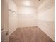 Spacious walk-in closet with carpet and multiple metal racks for optimal storage solutions at 7726 Coast Jay St, North Las Vegas, NV 89084