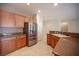 Open kitchen with stainless steel refrigerator, wooden cabinetry, and breakfast bar at 7726 Coast Jay St, North Las Vegas, NV 89084