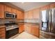 Charming kitchen showcasing stainless steel appliances and ample cabinet space at 7726 Coast Jay St, North Las Vegas, NV 89084