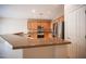 Bright kitchen with stainless steel appliances, breakfast bar, and warm-toned cabinets at 7726 Coast Jay St, North Las Vegas, NV 89084