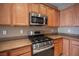 Close-up showcasing the stainless steel stove and microwave in this kitchen at 7726 Coast Jay St, North Las Vegas, NV 89084