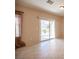 Sunny living area with sliding glass doors offering a view of the outdoor landscape and easy access to the backyard at 7726 Coast Jay St, North Las Vegas, NV 89084
