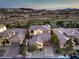 Sunset aerial view of a home in a golf community; features tile roof, well-manicured landscaping and solar panels at 79 Rezzonico Dr, Henderson, NV 89011