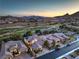 Panoramic aerial shot of a lovely golf course community; houses have tile roofs, stunning sunsets and mountain views at 79 Rezzonico Dr, Henderson, NV 89011