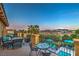 Expansive balcony offers panoramic mountain views, stylish patio furniture, and a private seating area by the pool at 79 Rezzonico Dr, Henderson, NV 89011