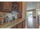 Entertaining bar with granite counters, tile backsplash, and wine storage at 79 Rezzonico Dr, Henderson, NV 89011