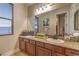 Bathroom featuring granite countertops, double sinks, and framed mirror at 79 Rezzonico Dr, Henderson, NV 89011