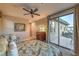 Spacious bedroom with a ceiling fan, a queen-sized bed and a sliding glass door at 79 Rezzonico Dr, Henderson, NV 89011