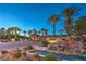 Beautiful entryway with stone walls, water features, desert landscaping, and tall palm trees providing a tranquil arrival at 79 Rezzonico Dr, Henderson, NV 89011
