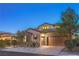 Charming home featuring a stone facade, tile roof, attached two-car garage, and well-manicured landscaping at 79 Rezzonico Dr, Henderson, NV 89011