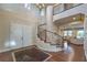 Grand foyer featuring a spiral staircase, dark wood flooring, and an open floor plan at 79 Rezzonico Dr, Henderson, NV 89011