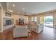 Open living room with hardwood floors, fireplace, and sliding doors to backyard pool at 79 Rezzonico Dr, Henderson, NV 89011