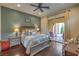 Comfortable bedroom with patio access, hardwood floors, and stylish decor at 79 Rezzonico Dr, Henderson, NV 89011