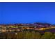 Breathtaking night view showcases the city lights against a mountain backdrop, illuminating the surrounding community at 79 Rezzonico Dr, Henderson, NV 89011
