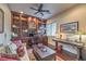 Well-appointed home office featuring custom built-ins, a ceiling fan, and hardwood floors at 79 Rezzonico Dr, Henderson, NV 89011
