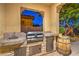 Stylish outdoor kitchen equipped with stainless steel appliances, perfect for grilling and outdoor dining at 79 Rezzonico Dr, Henderson, NV 89011