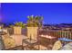 Enjoy the views from this expansive patio featuring a modern fire pit, plush seating, and lush greenery at 79 Rezzonico Dr, Henderson, NV 89011