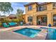 Inviting backyard pool and spa with beautiful patio furniture and landscaping, perfect for outdoor entertaining at 79 Rezzonico Dr, Henderson, NV 89011