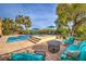 Relaxing backyard with pool, lounge chairs, and a cozy seating area, perfect for enjoying the outdoors at 79 Rezzonico Dr, Henderson, NV 89011