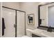 Modern bathroom featuring a walk-in shower with a glass enclosure, elegant vanity, and sleek fixtures at 824 Weston Ridge St, Henderson, NV 89011