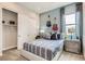 Stylish bedroom featuring a sliding door closet, guitars on the wall, and a comfortable bed at 824 Weston Ridge St, Henderson, NV 89011