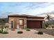 Charming single-story home featuring desert landscaping, a two-car garage, and a welcoming entryway at 824 Weston Ridge St, Henderson, NV 89011