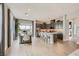 Bright open concept kitchen with a large island, stainless steel appliances, and a dining area at 824 Weston Ridge St, Henderson, NV 89011