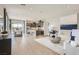 Open-concept living room flows into the modern kitchen with stainless appliances and a dining area with mountain views at 824 Weston Ridge St, Henderson, NV 89011