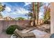 Backyard featuring block wall, desert landscaping and lounge chair on stone patio at 832 Clear Diamond Ave, Las Vegas, NV 89123