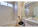 Bathroom featuring tiled shower-tub, toilet, and vanity with sink and large mirror at 832 Clear Diamond Ave, Las Vegas, NV 89123