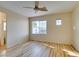 Bedroom featuring ceiling fan, wood floors, neutral walls, and exterior view at 832 Clear Diamond Ave, Las Vegas, NV 89123