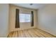Bright bedroom featuring wood floors, neutral walls, window with curtains and blinds at 832 Clear Diamond Ave, Las Vegas, NV 89123