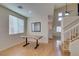 Bright dining area featuring a custom wood table, window and stairs leading upstairs at 832 Clear Diamond Ave, Las Vegas, NV 89123