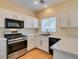 Well-lit kitchen with modern appliances, white cabinets, and a stainless steel oven at 832 Clear Diamond Ave, Las Vegas, NV 89123