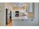 Bright kitchen features stainless steel appliances, white cabinetry, and a breakfast bar at 832 Clear Diamond Ave, Las Vegas, NV 89123