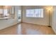Bright living room with wood floors adjacent to a kitchen area with outdoor access at 832 Clear Diamond Ave, Las Vegas, NV 89123