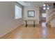 Bright living room with wood floors, table, staircase, and abundant natural light at 832 Clear Diamond Ave, Las Vegas, NV 89123