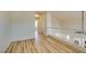 Upstairs space with neutral walls, white railing, and wood-look floors leading towards other rooms at 832 Clear Diamond Ave, Las Vegas, NV 89123